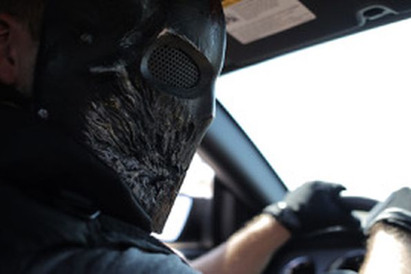 Stephen Ford driving car with bandana over his face