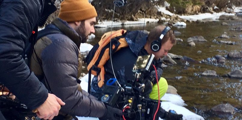 Ross Lara capturing sound by a river.