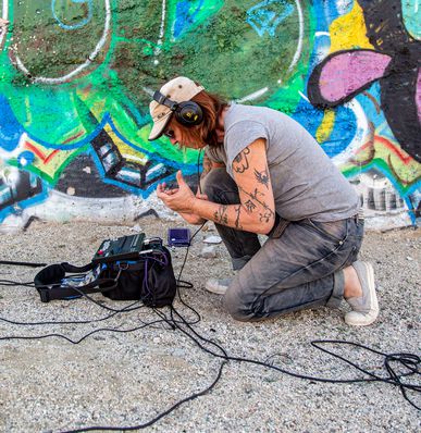 Sound designer check gear in the field