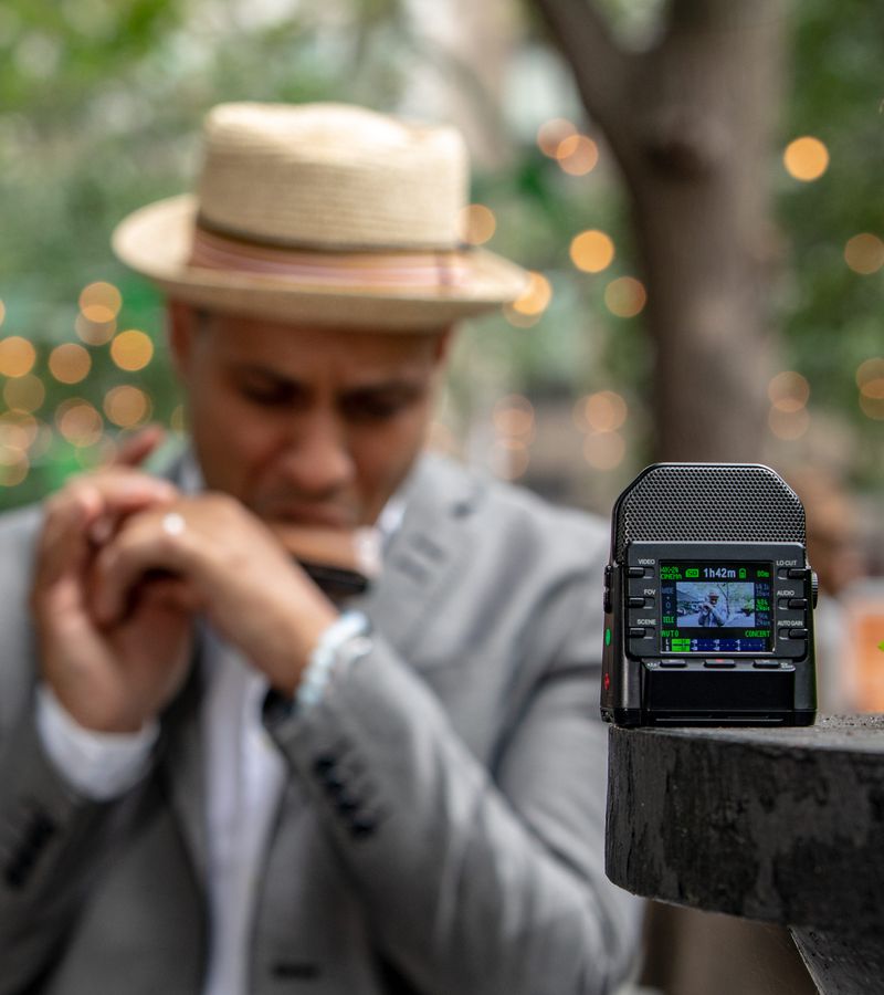 Grégoire Maret playing harmonica in the park and recording himself with a Q2n4K