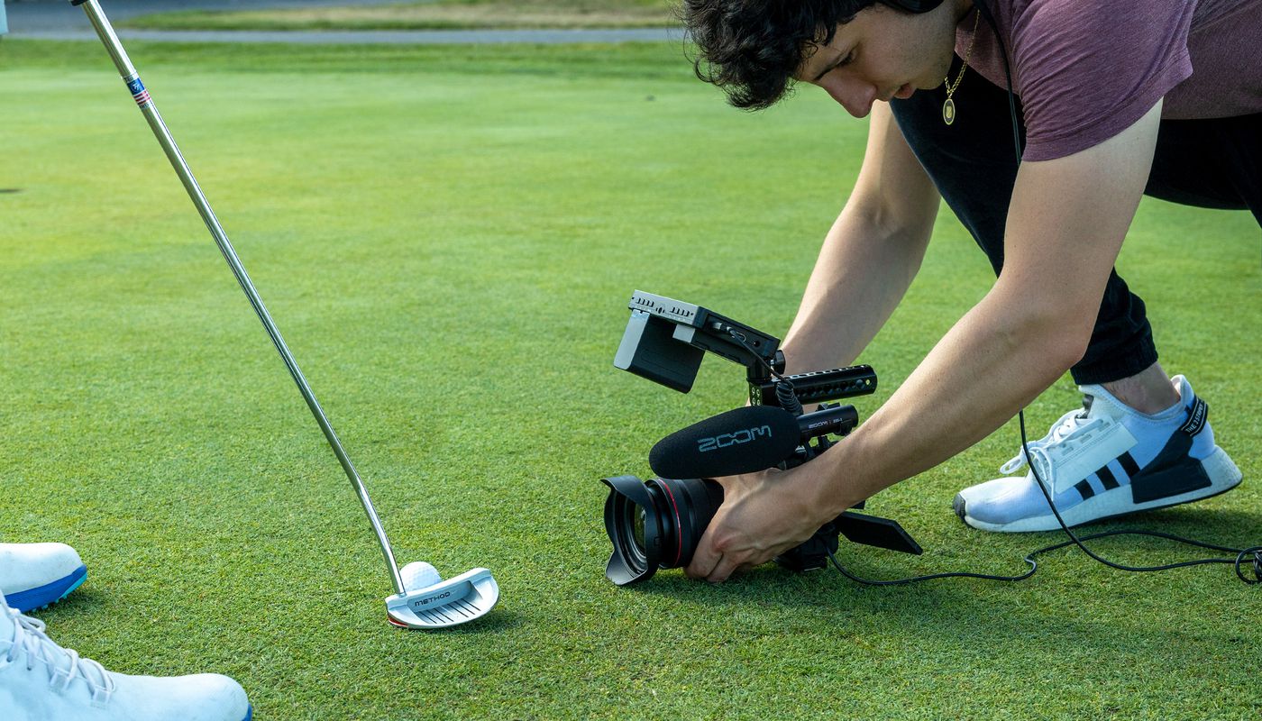 videographer capturing close-up content on the putting green with the ZSG-1 on his camera rig