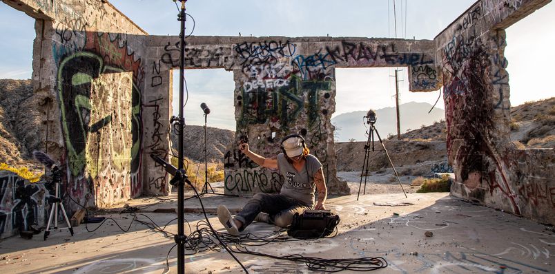 Paula Fairfield recording a pistol at a target range